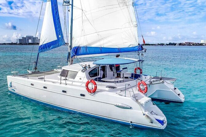 Catamaran Tour to Isla Mujeres from Cancún with Bar and Lunch - Open bar energy on a catamaran: fun, but plan your snorkeling