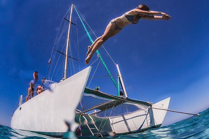 Discover Isla Mujeres: Catamaran, Snorkeling, and "Ice Bar" - On the water: catamaran ride, open national bar, and spinnaker flying