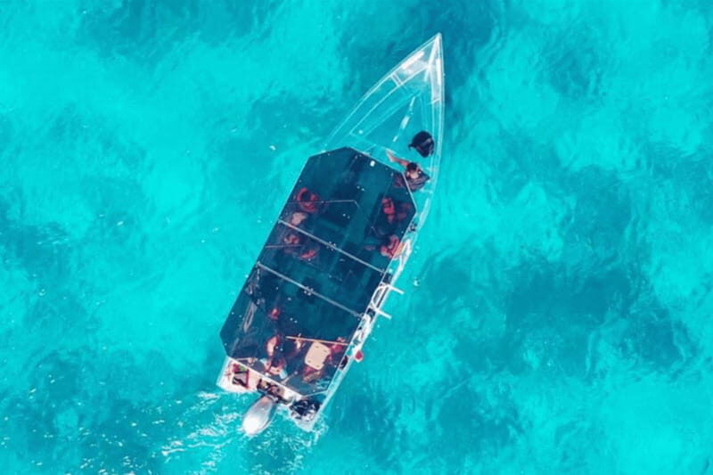 Explore the sea of cozumel in a transprent boat with drinks and snorkel. - The north-side cruise from Envatours to San Miguel pier